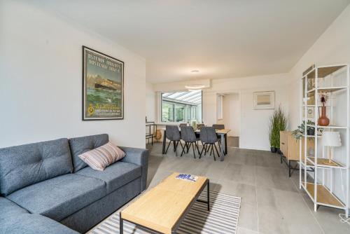 a living room with a couch and a table at maison des dunes in Ostend