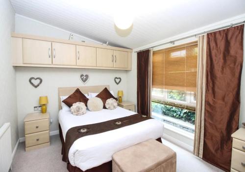 a bedroom with a large bed and a window at Waters Edge in Routh