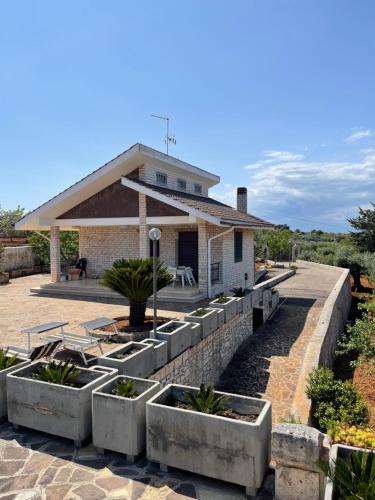 a house with concrete planters in front of it at Happy's Casa in Putignano