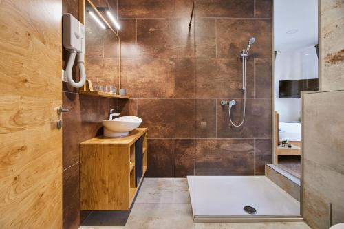a bathroom with a shower and a sink at Ob Krki Apartments in Kostanjevica na Krki