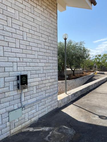 a brick wall with a phone on the side of a building at Happy's Casa in Putignano