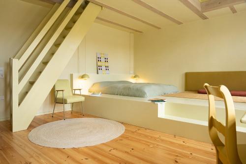 a bedroom with a bed and a staircase at St. Oberholz Woldzegarten Retreat in Leizen