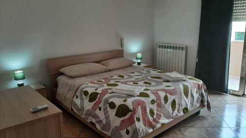a bedroom with a bed with a blanket on it at ORO BIANCO in Marsala