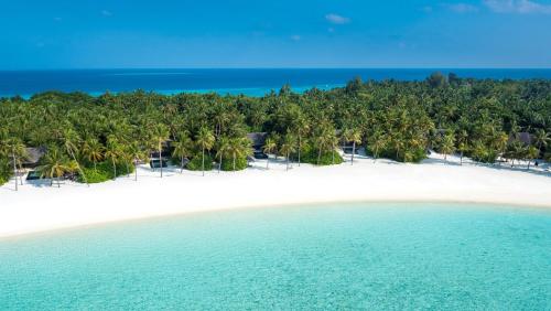 an aerial view of a beach with palm trees and the ocean at One&Only Reethi Rah in Reethi Rah