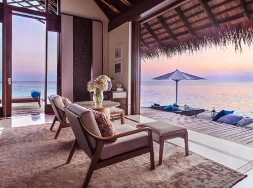 a dining room with a view of the ocean at One&Only Reethi Rah in Reethi Rah