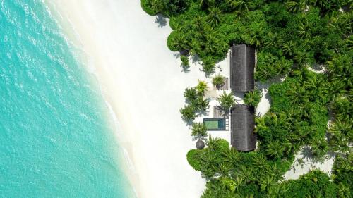 an aerial view of an island with a resort at One&Only Reethi Rah in Reethi Rah