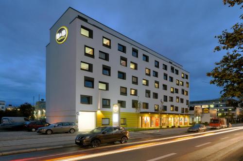 a building with a clock on the side of it at B&B Hotel München City-West in Munich