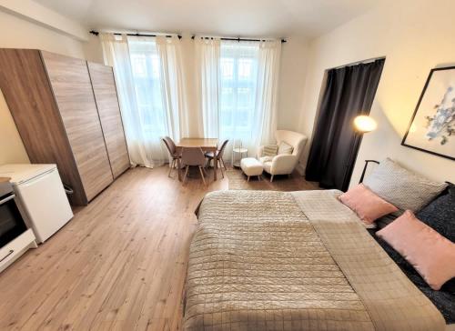 a bedroom with a bed and a table and chairs at Cozy apartment close to Palmovka in Prague
