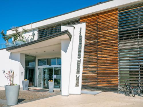 a facade of a building with wood panels at Parc Hotel Germano Suites & Apartments in Bardolino