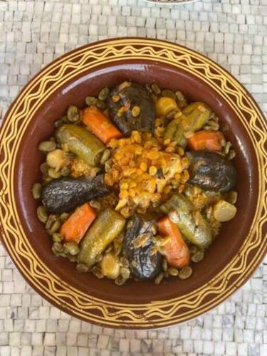 a bowl of food with vegetables in it on a table at Dar Lily, villa familiale avec piscine et services in Skoura