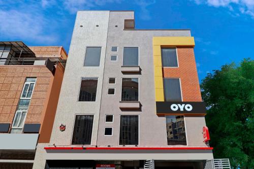 a building with an ovy sign on the side of it at Hotel Royal Comfort Near Cubbon Park in Bangalore