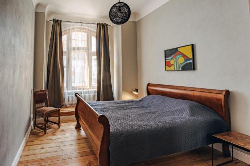 a bedroom with a bed and a window at Constantine Apartments in Riga