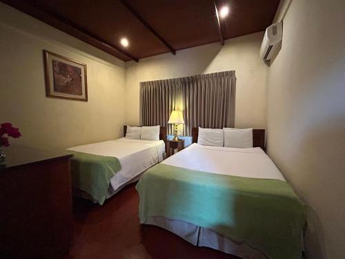 a hotel room with two beds in a room at Hotel del Patio in Flores