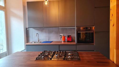 a kitchen with a stove top oven and a sink at Casa Claudia Pieve centro storico in Tremosine Sul Garda