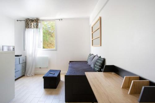 un salon avec un lit et une table dans l'établissement Charmant Studio avec parking, à Nice