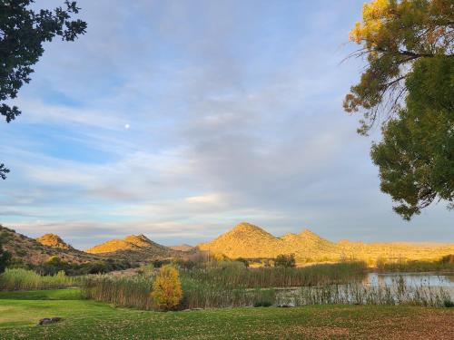 a view of a valley with mountains and a lake at Big Sky Ranch in Colesberg