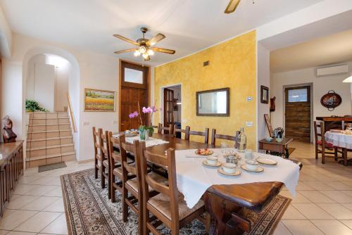 a dining room and living room with a table and chairs at Cascina Nonna Nina in Credaro
