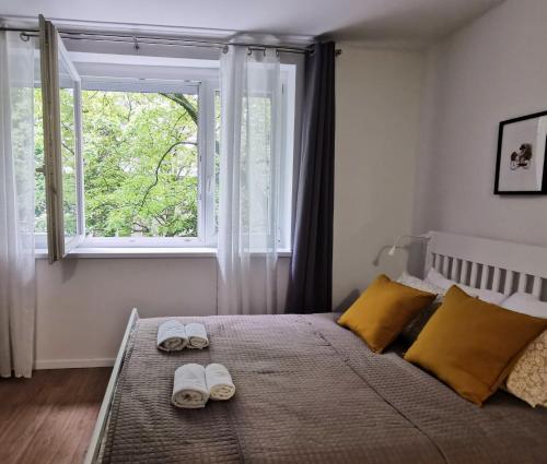 a bedroom with a bed with two slippers on it at Studio apartman Mirta in Varaždin
