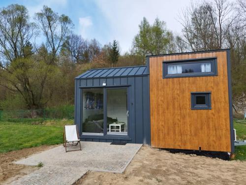 a tiny house with a wooden wall at Gospodarstwo Agroturystyczne Sunny Camp in Jerzmanowice