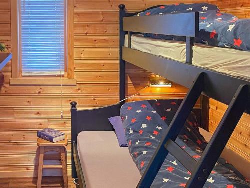 a bedroom with two bunk beds in a cabin at Holiday home Gratangen II in Gratangen