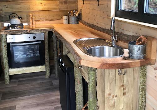 a kitchen with a sink and a stove at Old Oak Farm in Oakham
