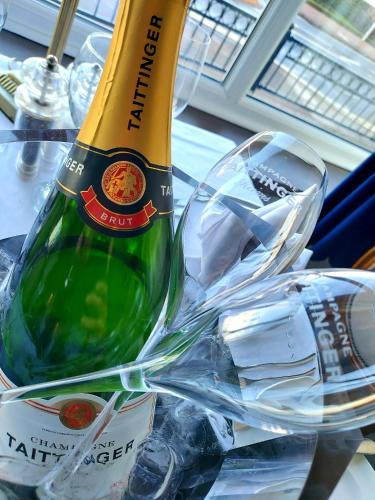 a bottle of champagne sitting on top of a table at Kingsway Hotel. in Cleethorpes