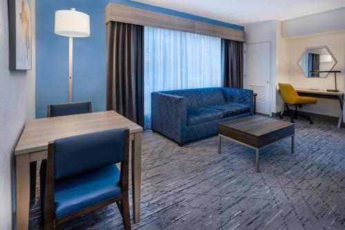 a living room with a couch and a table at Holiday Inn Express and Suites Tampa I-75 at Bruce B. Downs by IHG in Tampa
