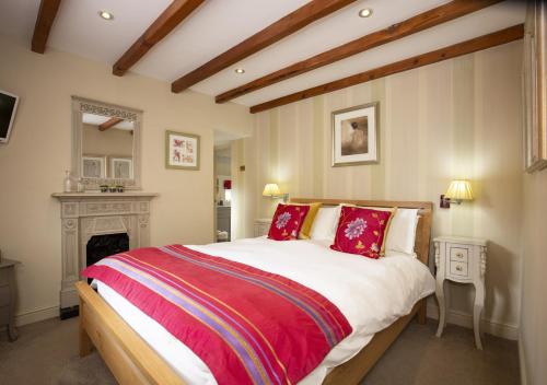 a bedroom with a large bed and a fireplace at The Piggery in Sleights