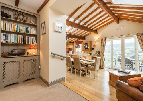 a living room with a table and a dining room at The Piggery in Sleights