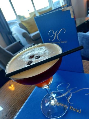 a drink in a wine glass sitting on a table at Kingsway Hotel. in Cleethorpes