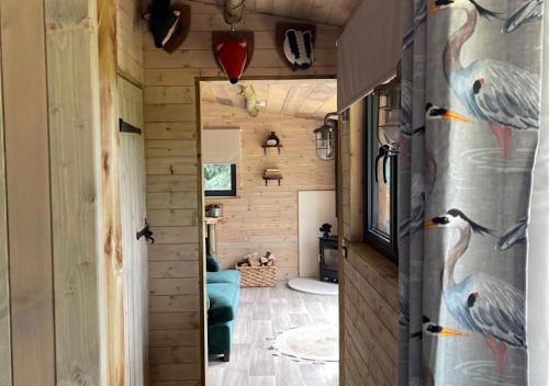 a tiny house with a hallway with a door at Old Oak Farm in Oakham