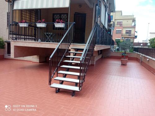 a staircase on the side of a building with flower boxes at La Posada Roma in Rome