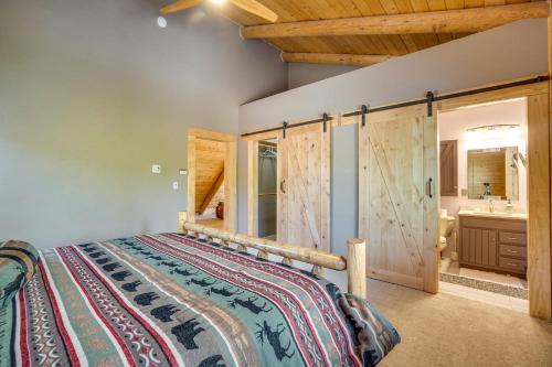 a bedroom with a large bed and a bathroom at Mountain-View Front Range Colorado Vacation Rental in Red Feather Lakes