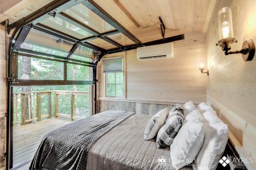 a bedroom in a tree house with a bed at The Blackjack Oak in Treehouse Grove at Norton Creek in Gatlinburg