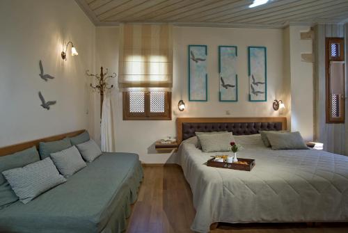 a bedroom with two beds and a couch at Ionas Boutique Hotel in Chania Town