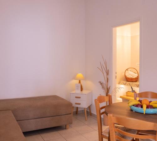 a living room with a bed and a table at Ammos Sifnos Village in Platis Yialos Sifnos