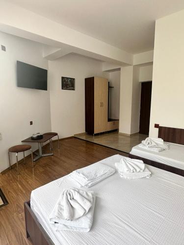 a room with two beds with towels on them at Paradox Oituz in Eforie Sud