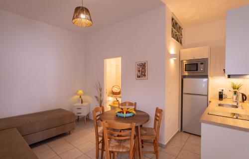 a kitchen and a living room with a table and a couch at Ammos Sifnos Village in Platis Yialos Sifnos