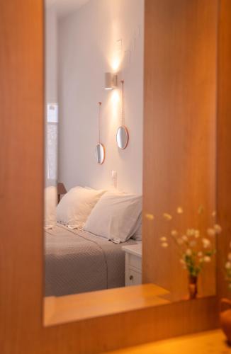 a mirror reflection of a bed in a bedroom at Ammos Sifnos Village in Platis Yialos Sifnos