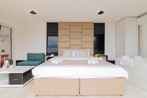 a bedroom with a large bed and a couch at Velestovo House in Ohrid