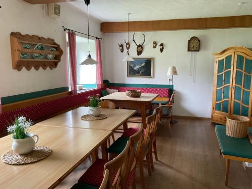 a dining room with wooden tables and chairs at Steiner Stammhaus in Vorderstoder