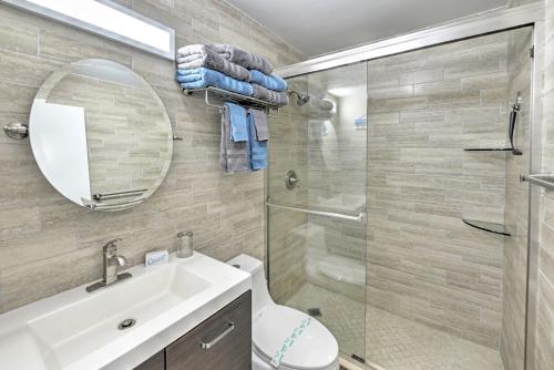 a bathroom with a shower and a toilet and a sink at Harbour Beach Resort in Daytona Beach