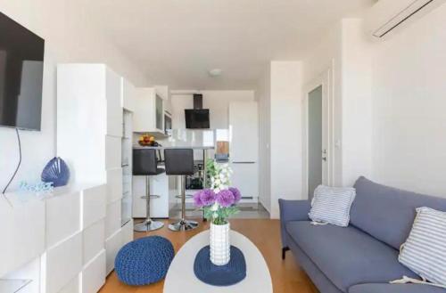 uma sala de estar com um sofá azul e uma mesa em Bookkeeper's Apartment Split em Split