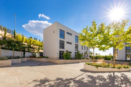 a white building with the sun in the sky at HADRIE LUXURY RESORT AND VILLAS Krk in Krk