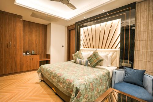 a hotel room with a bed and a chair at Atithi House in Greater Noida