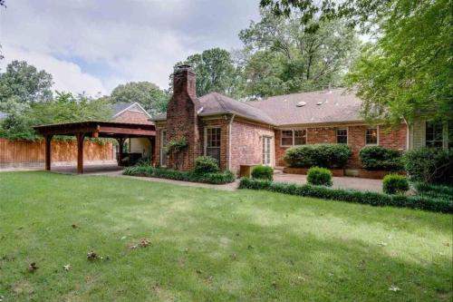 a brick house with a gazebo in a yard at Elegant 6 Bedroom Home in Heart of Memphis in Memphis