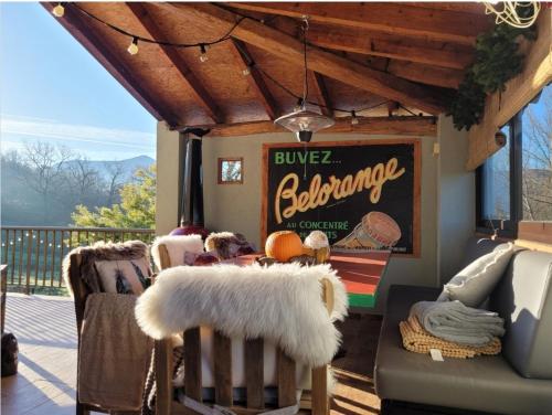 a porch with a baseball sign and chairs on a deck at Harveys Homestay - Adults only in Mieres
