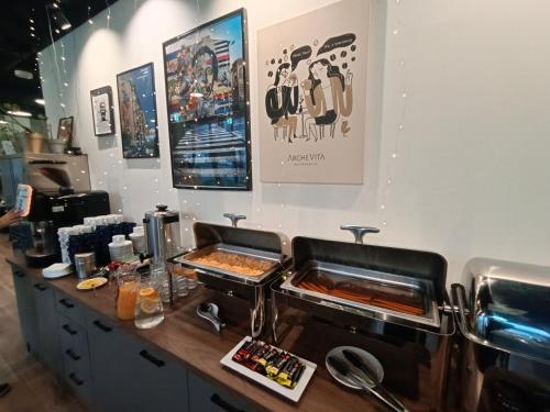 a kitchen with a counter with some food at Arche Residence Łódź in Łódź