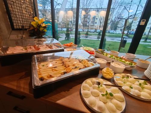 a buffet with many different types of food on a table at Arche Residence Łódź in Łódź