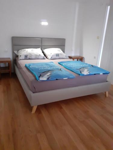 a bed with blue sheets and pillows on it at Lana 1 in Senj
